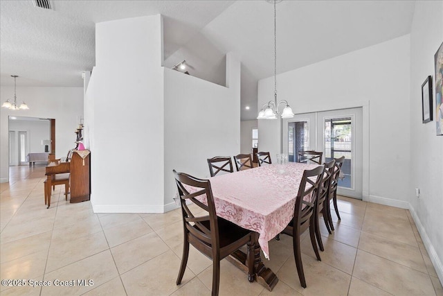 tiled dining room featuring high vaulted ceiling, a textured ceiling, a chandelier, and french doors