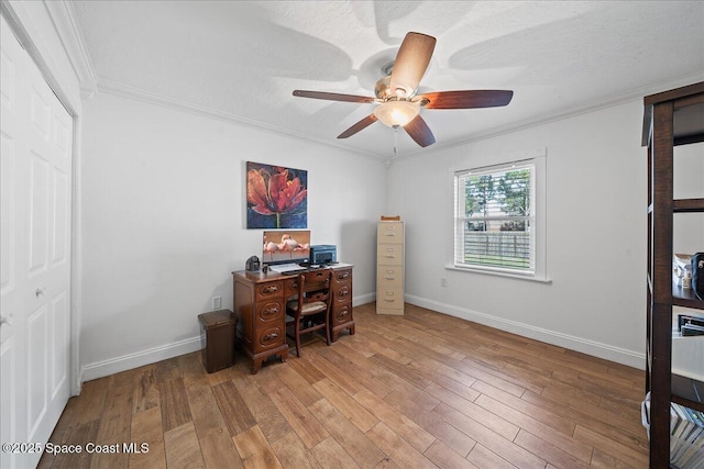 office space featuring hardwood / wood-style floors, crown molding, and ceiling fan