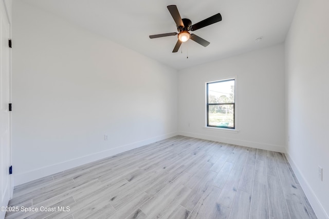 empty room with ceiling fan and light hardwood / wood-style floors