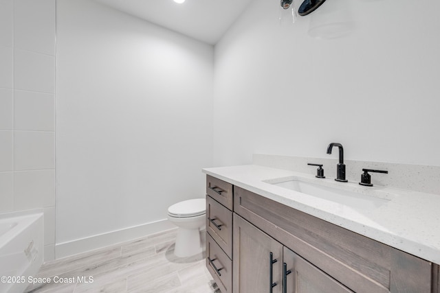 bathroom featuring toilet and vanity