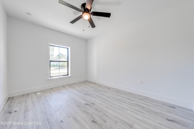 empty room featuring ceiling fan and light hardwood / wood-style flooring