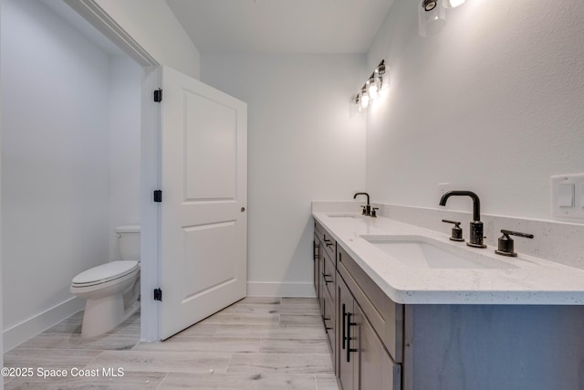 bathroom with toilet and vanity