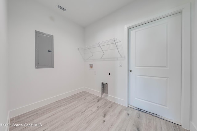 washroom featuring light hardwood / wood-style floors, washer hookup, electric dryer hookup, and electric panel