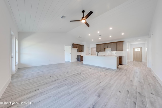 unfurnished living room with ceiling fan, vaulted ceiling, and light hardwood / wood-style flooring