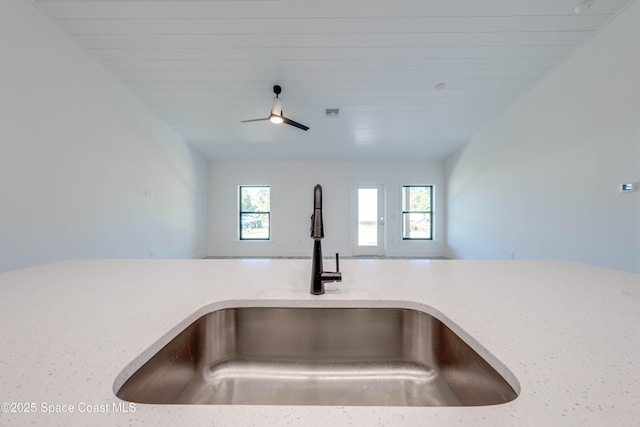 interior details featuring ceiling fan, sink, and wood ceiling