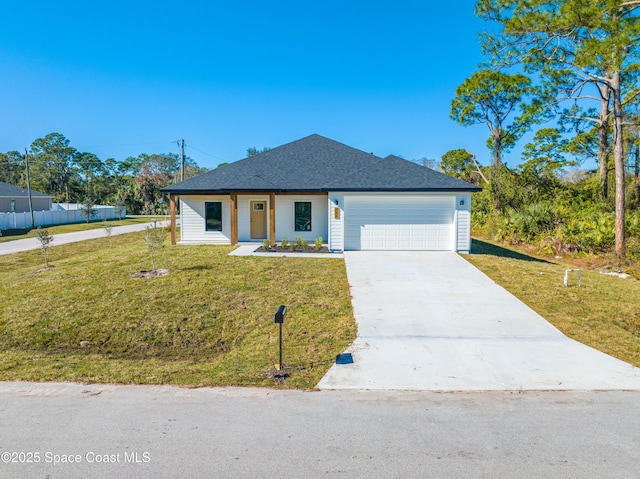 view of front facade with a front yard and a garage