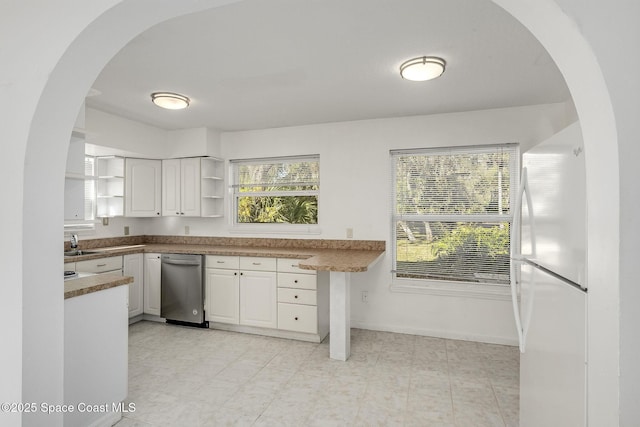 kitchen featuring white cabinetry and white fridge