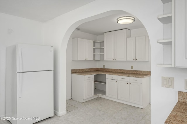 kitchen with white cabinets and white fridge