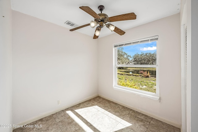 unfurnished room with ceiling fan and plenty of natural light