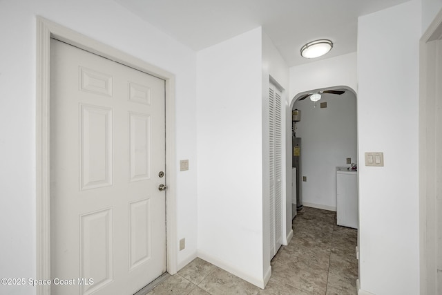 corridor featuring washer / dryer and electric water heater