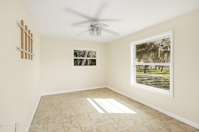 tiled spare room featuring ceiling fan