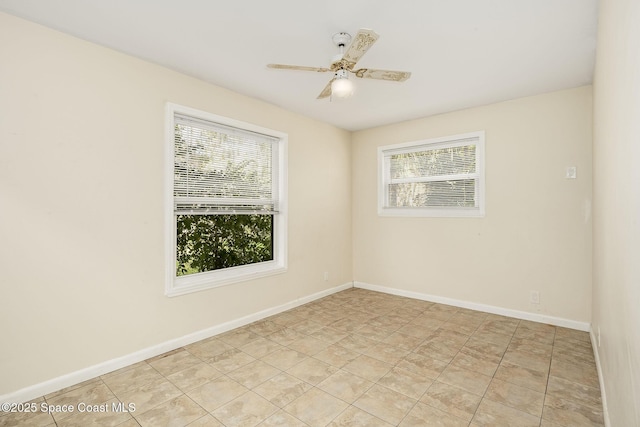 spare room featuring ceiling fan and light tile patterned floors