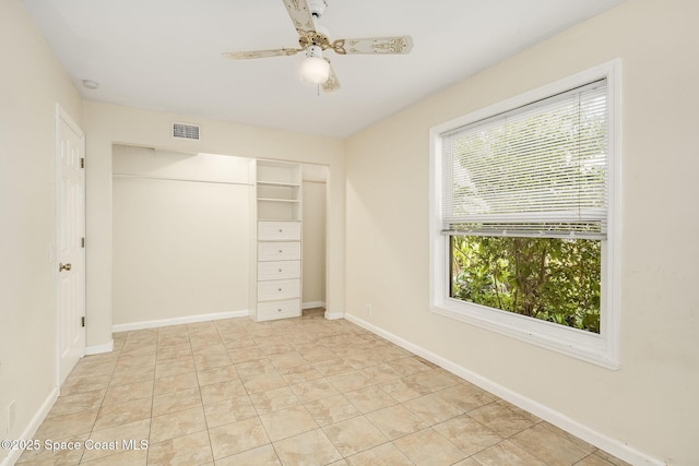 spare room featuring light tile patterned flooring and ceiling fan