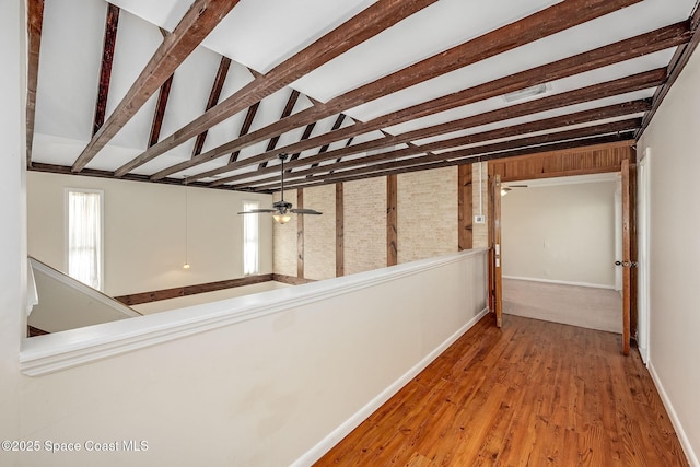 corridor featuring lofted ceiling with beams and wood-type flooring