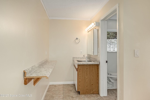 bathroom featuring toilet, crown molding, a textured ceiling, vanity, and tile patterned flooring