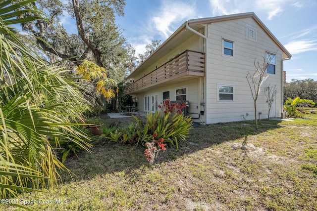 rear view of property featuring a balcony