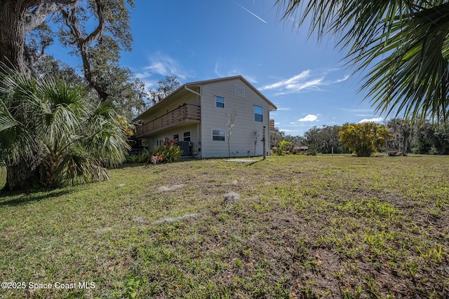 exterior space with central AC and a yard