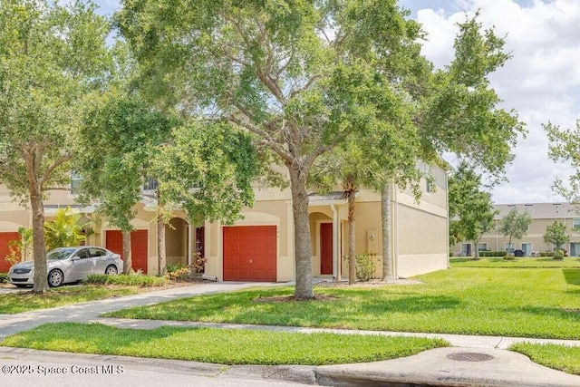 view of front facade featuring a garage and a front yard