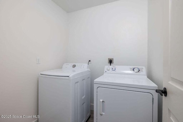 laundry room with washing machine and clothes dryer