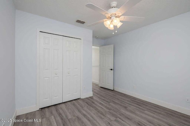 unfurnished bedroom with a closet, ceiling fan, and light hardwood / wood-style flooring