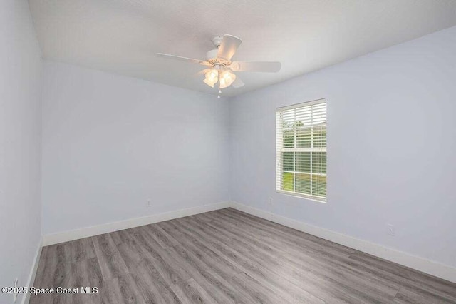 unfurnished room with hardwood / wood-style flooring and ceiling fan