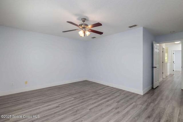 unfurnished room featuring light wood-type flooring and ceiling fan