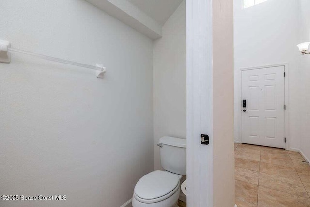 bathroom with toilet and tile patterned floors