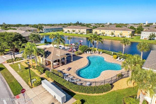 view of pool featuring a water view and a patio