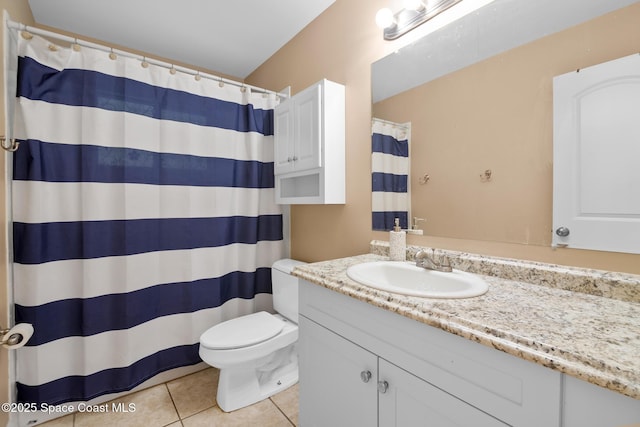 bathroom featuring vanity, toilet, curtained shower, and tile patterned flooring