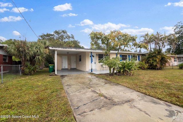 ranch-style home featuring a carport and a front lawn