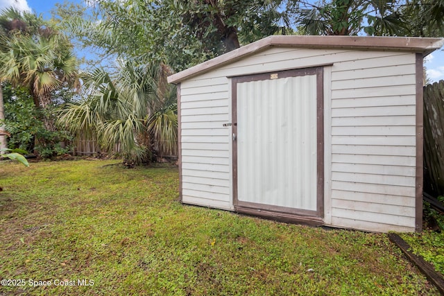 view of outbuilding featuring a yard