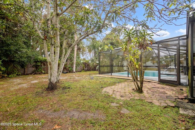 view of yard with a fenced in pool, a lanai, and a patio