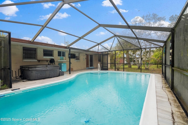 view of swimming pool featuring a lanai, a hot tub, and a patio