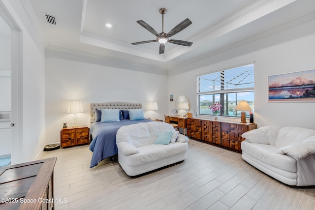 bedroom with ceiling fan, ornamental molding, and a raised ceiling