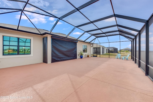 view of patio featuring a lanai