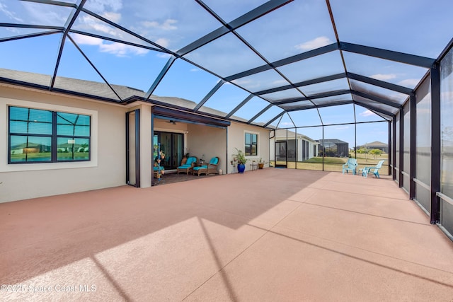 view of patio / terrace with ceiling fan and glass enclosure