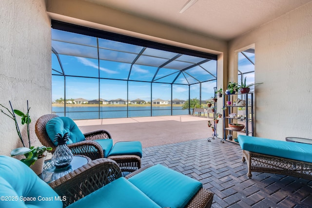 view of patio featuring glass enclosure and a water view