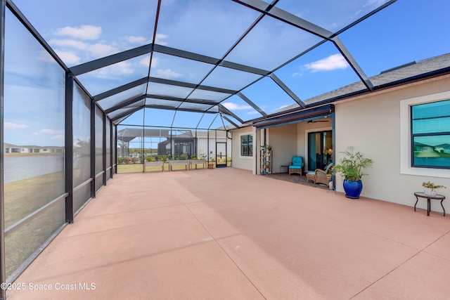 unfurnished sunroom featuring a water view