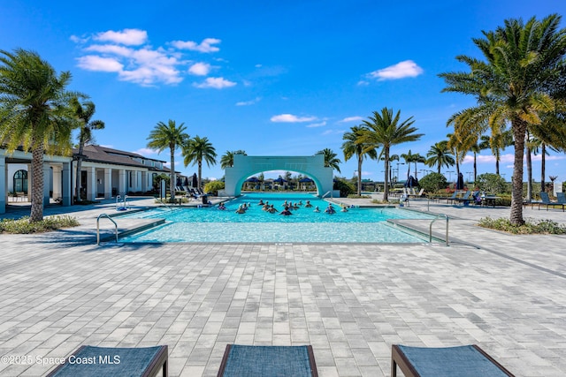 view of swimming pool featuring a water slide and a patio