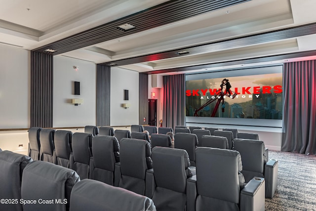 home theater featuring a raised ceiling and carpet