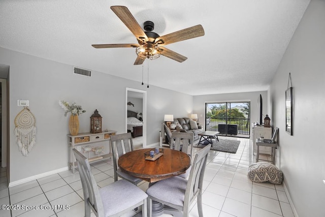 dining area with ceiling fan and light tile patterned floors