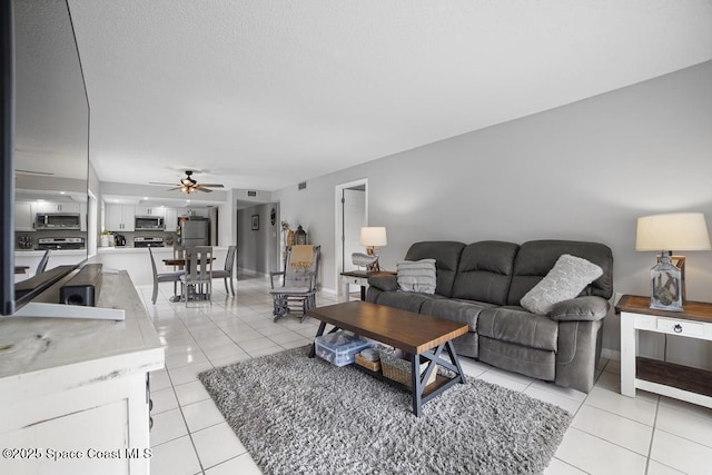 tiled living room featuring ceiling fan