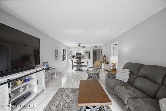 tiled living room with ceiling fan