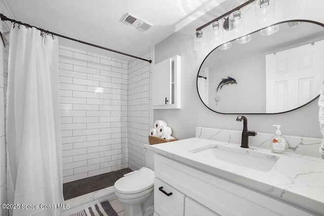 bathroom featuring toilet, vanity, and a shower with curtain