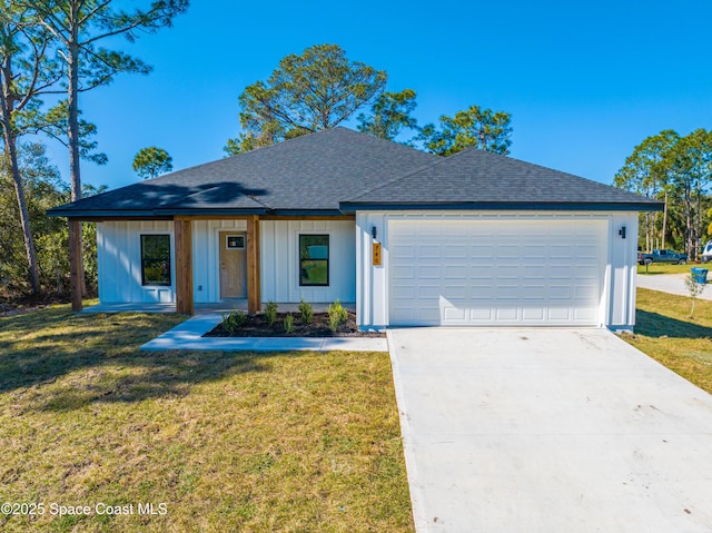 view of front of property with a front lawn and a garage