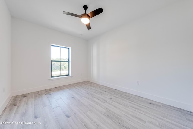 empty room with ceiling fan and light hardwood / wood-style floors