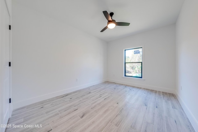 empty room featuring ceiling fan and light hardwood / wood-style flooring