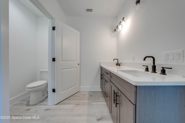 bathroom featuring toilet and vanity