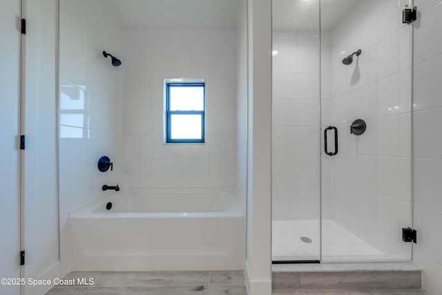 bathroom with independent shower and bath and wood-type flooring