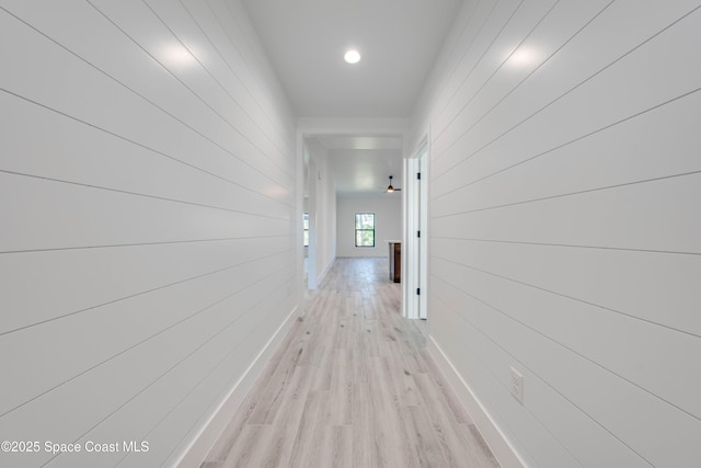 hallway with light hardwood / wood-style floors